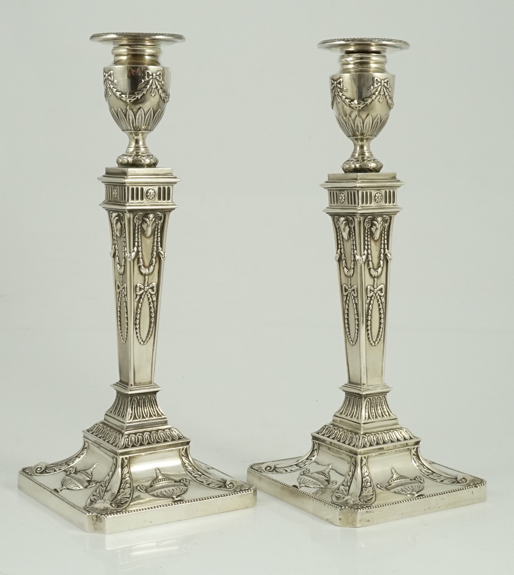 A pair of Elizabeth II Adam style silver candlesticks, by Barker Ellis Silver Co